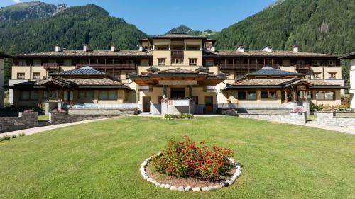 a large house with a garden in front of it at Residenza Del Sole in Gressoney-Saint-Jean