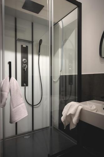 a bathroom with a shower and a sink at NOOQA - Villa RHEINLOFTS in Cologne