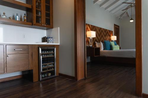 a room with a bed and a wine cellar at Hammock Cove Antigua - All Inclusive - Adults Only in Willikies