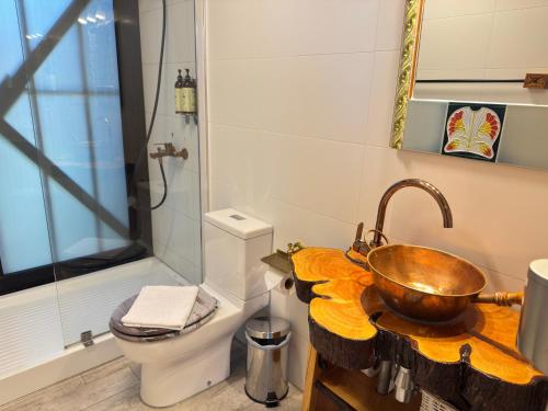 a bathroom with a sink and a toilet at AYCA La Flora Hotel Boutique in Valparaíso