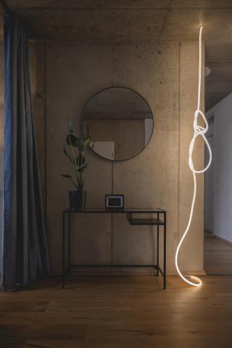 a room with a table and a mirror at NOOQA - Villa RHEINLOFTS in Cologne