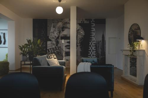 a living room with two blue chairs and a fireplace at NOOQA - Villa RHEINLOFTS in Cologne