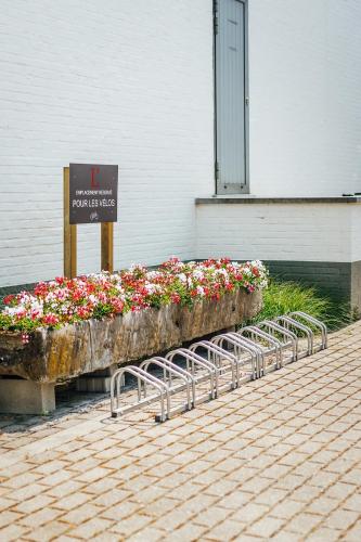 a display of flowers in front of a building at Relais de L'Empereur in Genappe