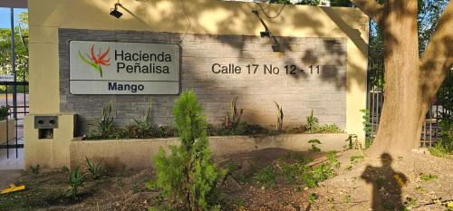 a sign on the side of a building at Hacienda Peñalisa Mango in Ricaurte