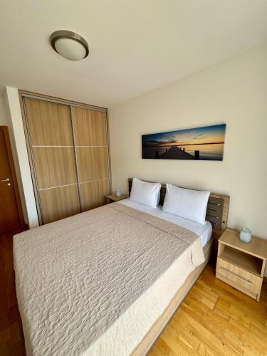 a bedroom with a large bed in a room at Infinity Apartment Blue Horizont Przno in Budva