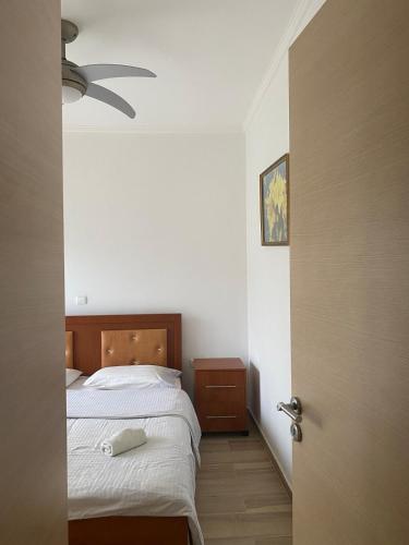 a bedroom with a bed and a ceiling fan at Main Seaview apartment Orikum in Orikum