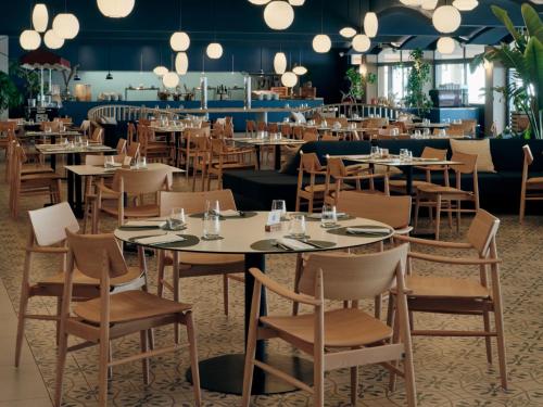 a restaurant with tables and chairs in a room at Mangia's Torre Del Barone Resort & SPA in Sciacca