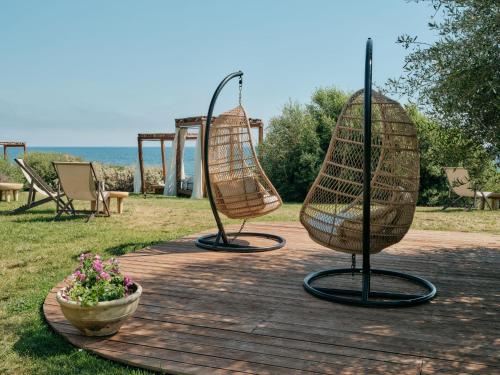 two sculptures of chairs and a flower pot on a patio at Mangia's Torre Del Barone Resort & SPA in Sciacca