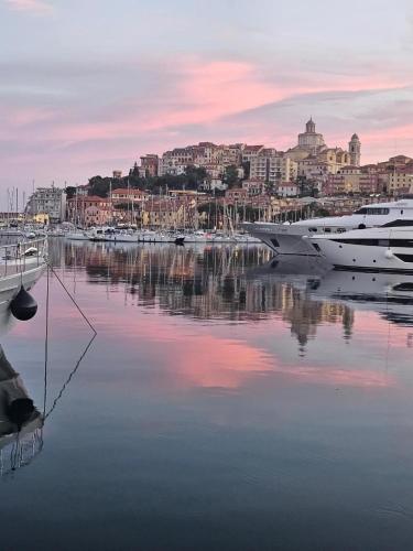 a boat is docked in a harbor with a city at Casa Elisa Montegrazie in Montegrazie