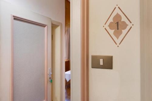 a door to a room with a mirror and a hallway at Unterdornerhof Algund in Lagundo