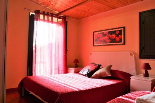 a bedroom with two beds and a window at Gaia Holidays in Cefalù