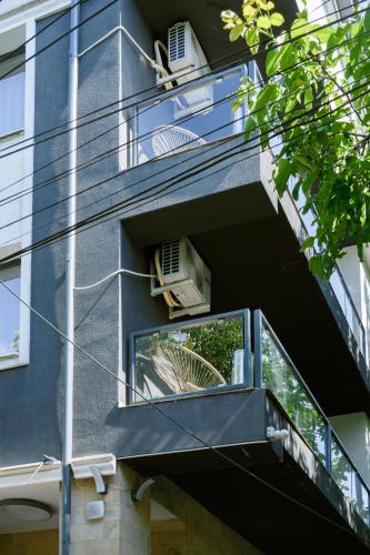 an apartment building with a balcony with two air conditioners at Hotel Palas Grand View in Iaşi