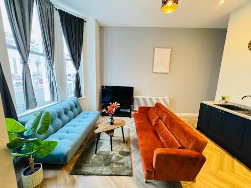 a living room with a couch and a table at Grande View 8 in Eastbourne