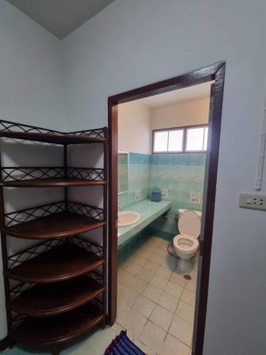 a bathroom with a toilet and a tub and a sink at Floral House in Lamai