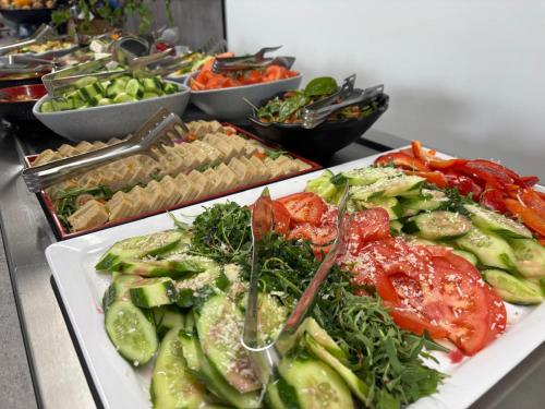 a buffet with plates of food on a table at Apartamenty Rondo in Świnoujście