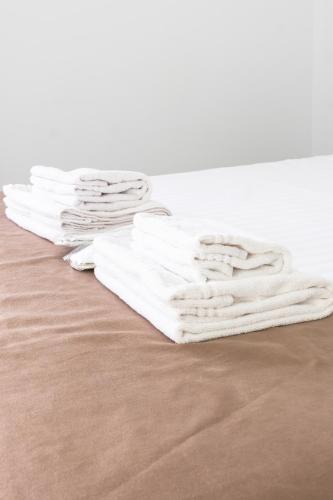 a pile of white towels sitting on the floor at Hotel Palas Grand View in Iaşi