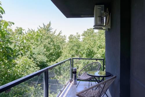 a balcony with two chairs and a table on it at Hotel Palas Grand View in Iaşi