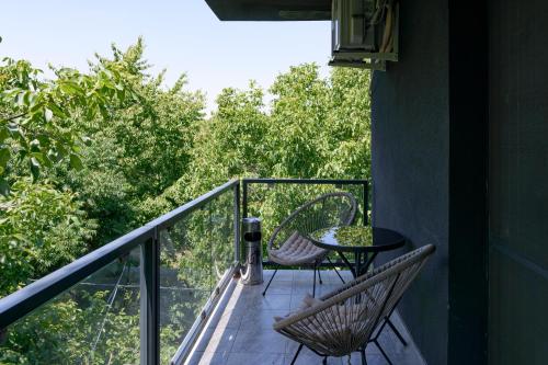 a balcony with two chairs and a table on it at Hotel Palas Grand View in Iaşi