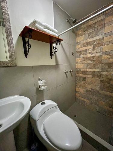 a bathroom with a toilet and a sink and a shower at Real Marquez in Trujillo