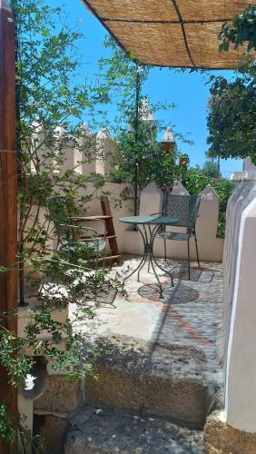 a patio with a table and chairs on a patio at Casa Aranci in Marsala