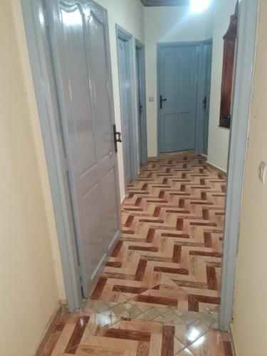 a hallway with wooden flooring and two doors at safi central apartments in Safi