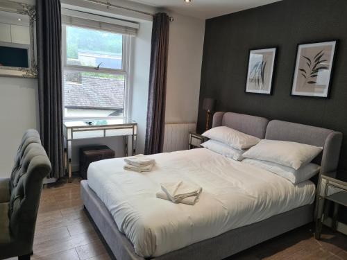 a bedroom with a bed with two books on it at Heart of Bowness in Bowness-on-Windermere