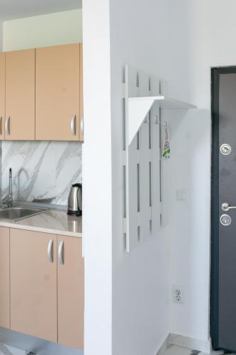 a kitchen with white cabinets and a sink at Hotel Palas Grand View in Iaşi