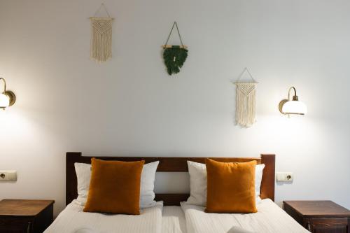 a bedroom with a bed with orange pillows and lights at ZimaSnow Ski & Spa Club in Bukovel
