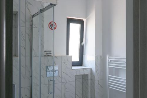a bathroom with a shower and a window at Hotel Palas Grand View in Iaşi