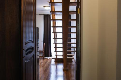 a hallway with a spiral staircase in a house at ZimaSnow Ski & Spa Club in Bukovel