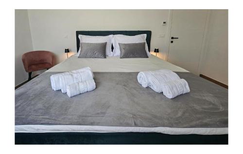 a large bed with two white towels on it at Gorgeous Home In Sveti Ivan Zelina in Sveti Ivan Zelina