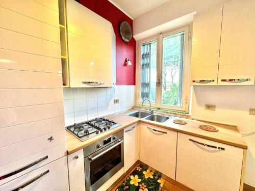 a small kitchen with a sink and a stove at Pineta Apartament in Tirrenia