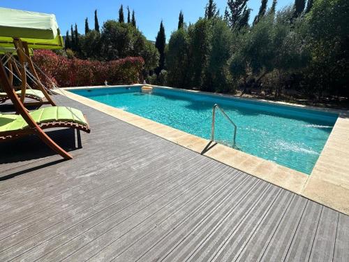 una gran piscina con terraza de madera en Habitacion Oliva, en Olvera