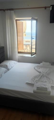 a bedroom with a bed with a view of the ocean at Ionian Sunset House in Piqeras