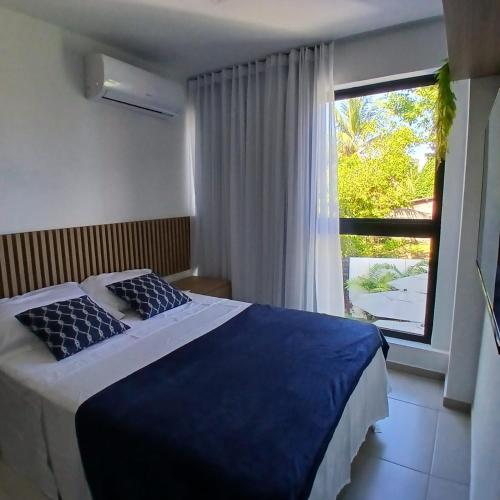 Ένα ή περισσότερα κρεβάτια σε δωμάτιο στο Acolhedor Flat em Tamandaré