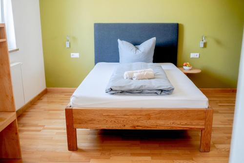 a bed with two stuffed animals sitting on it at Hotel Donau-Ries in Mertingen