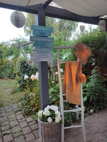 a group of signs on a pole with a chair at Wohnen im NATURNEST in Podersdorf am See