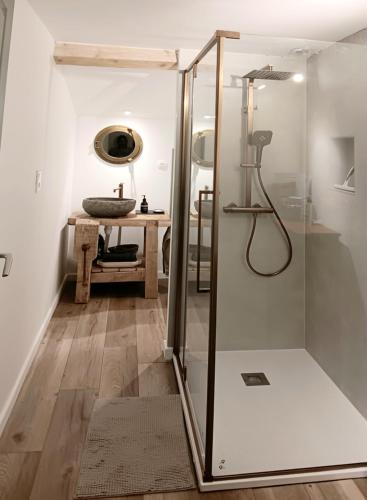 une douche avec une porte vitrée dans une salle de bain dans l'établissement La petite Sorbonne, à Malleval