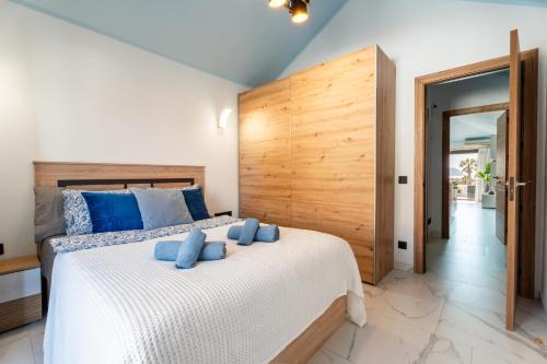 a bedroom with a large bed with blue pillows on it at The Skippers Nest in San Miguel de Abona