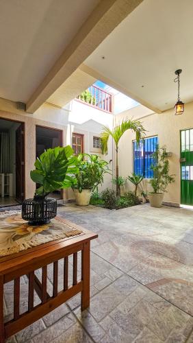 a patio with a table and some plants at Morro Branco Pousada e aptos in Natal