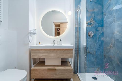 a bathroom with a sink and a mirror at Your Holidays Bel Mare Aqua F203 in Międzyzdroje