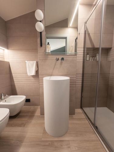 a bathroom with a toilet and a sink and a shower at Hotel Duomo Cremona in Cremona