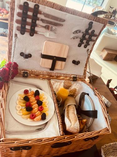 a picnic basket with a plate of food and bread at Domaine FINCA LESSYA, Lodge insolite & SPA in Mauguio
