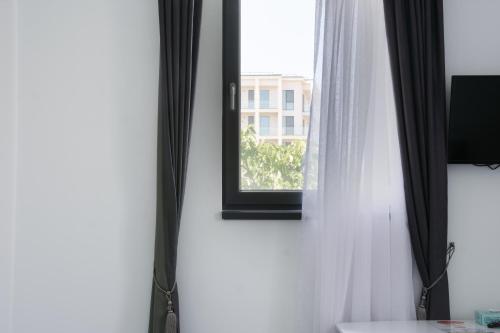 a mirror on a wall next to a window at Hotel Palas Grand View in Iaşi