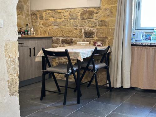 a kitchen with a table and two chairs in a kitchen at Cuturissi Hospitality & Wellness in Ragusa