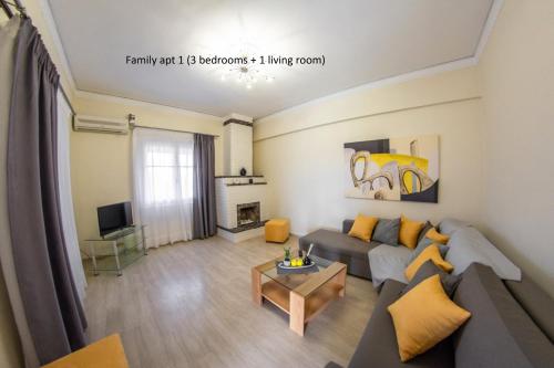 a living room with a couch and a table at Elaionas Holiday Home studios and apartments in Agios Stefanos