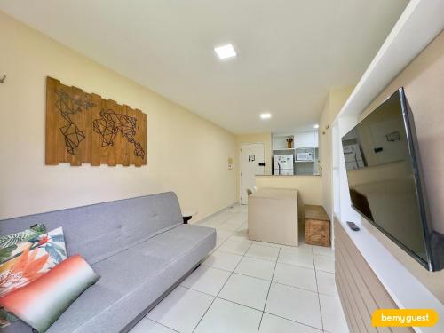 a living room with a couch and a flat screen tv at Resort VG SUN por Be My Guest! in Caucaia