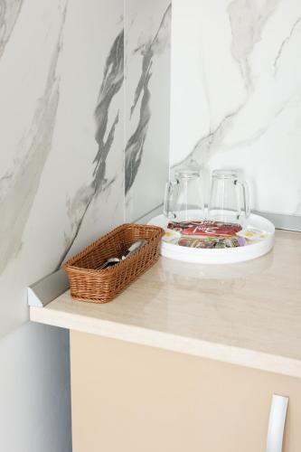 a table with two glasses and a basket on it at Hotel Palas Grand View in Iaşi