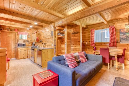 a living room with a blue couch in a log cabin at Sno-bird #8 in Government Camp