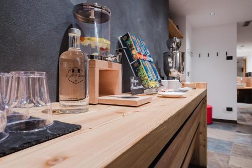 a bottle of alcohol sitting on a wooden counter at Hotel Li Anta Rossa - Adults Only in Livigno